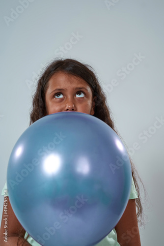 Thoughtful little girl hold balloon and look up © Svitlana