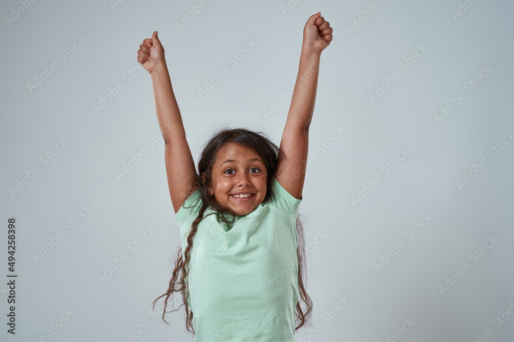Latin little girl with hands in air celebrate win Latin little girl with hands in air celebrate win