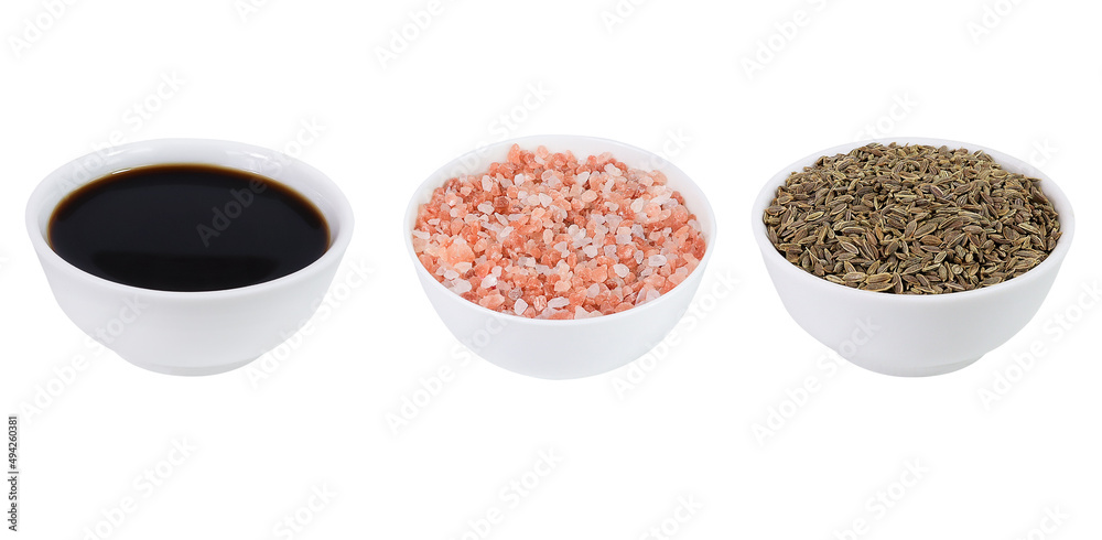 Set of spices and sauce. Cumin, Himalayan salt and soy sauce on an isolated white background. Set of spices and sauce. Cumin, Himalayan salt and soy sauce on an isolated white background.