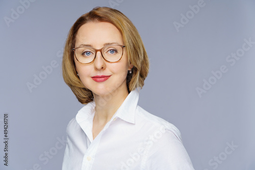  woman in casual posing over white studio background. Portrait of cheerful successful middle aged business lady