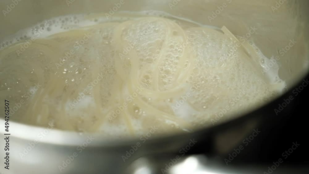 Spaghetti in boiling water in a saucepan top view Spaghetti in boiling water in a saucepan top view