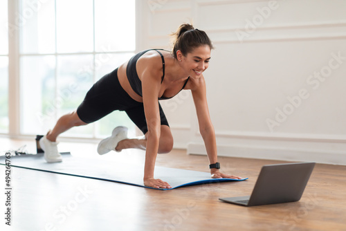 Cheerful Woman Doing Cross Body Mountain Climbers Exercise