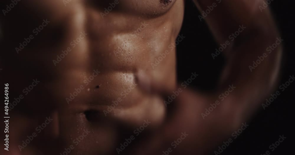 Touching his body and flexing, tilt shift