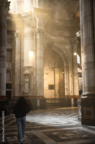Girl walking inside the cathedral of Cádiz
