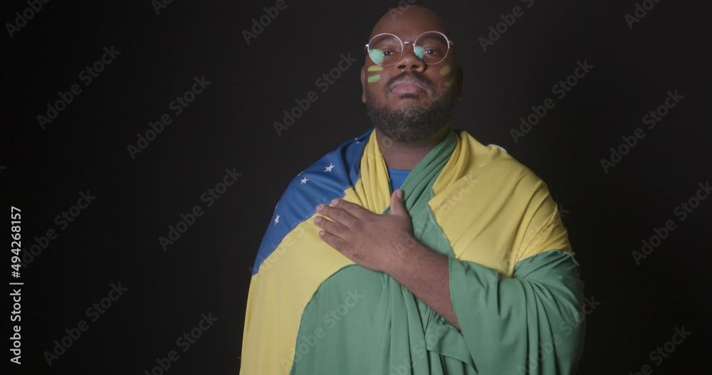 Afro Brazilian man, wearing Brazilian clothes, soccer fan, singing the