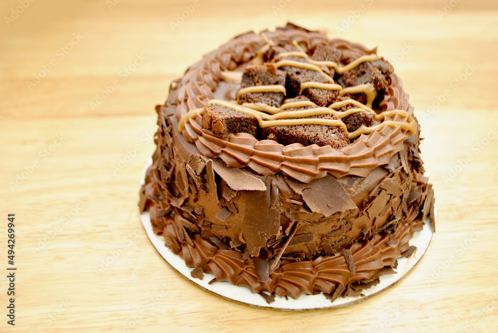 Whole Fudge Chocolate Cake Topped with Brownies and Caramel	