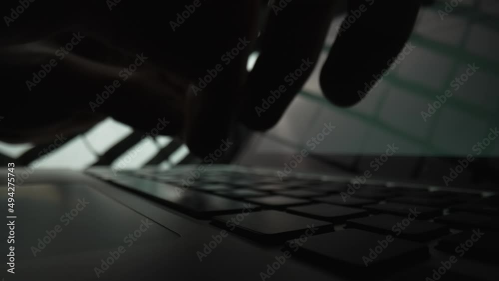 Man writes message to social network. Male hands typing on notebook keyboard in dark . Writer writes article in media. Working on laptop, typing on keyboard, online business. Close up. Slow motion.