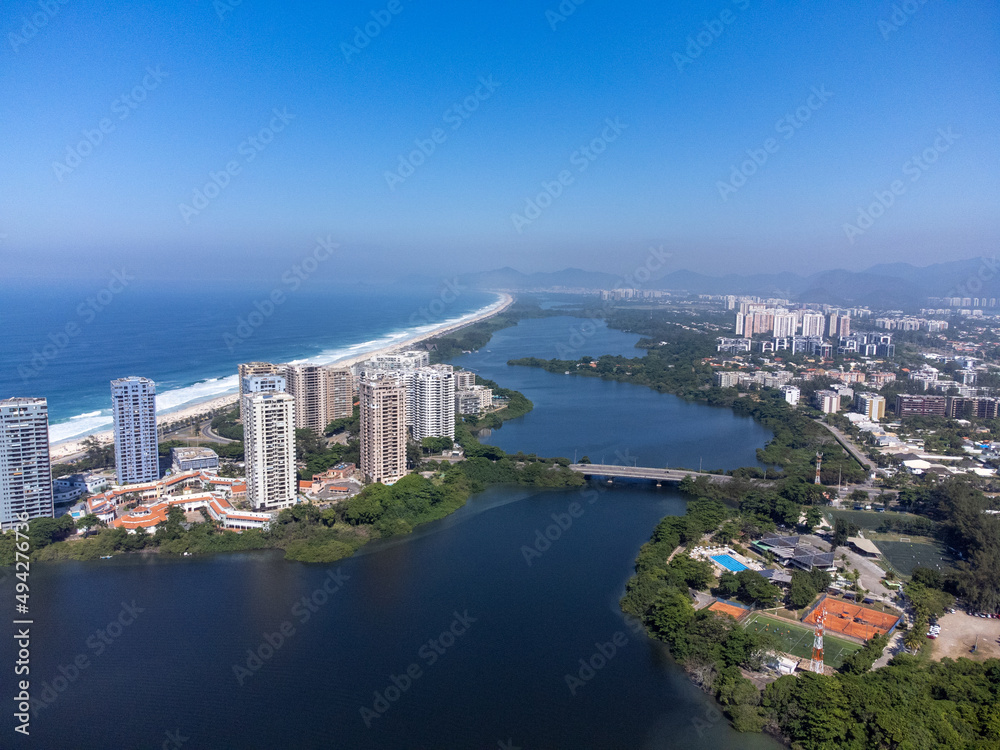Amazing seaside town in the middle of the mountains with a river flowing - drone aerial view - Barra da Tijuca, Rio de Janeiro, RJ, Brazilian Beach