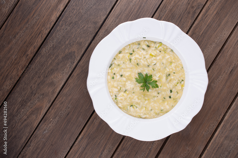 risotto with parsley viewed from above on rustic wooden table