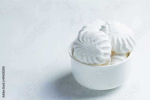 Vanilla Marshmallow dessert zephyr. Airy Meringue dessert in a white bowl on the white background. traditional Russian sweet dessert. copy space