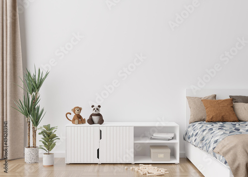 Empty white wall in modern child room. Mock up interior in scandinavian style. Free, copy space for your picture, poster. Bed, rattan basket, toys. Cozy room for kids. 3D rendering.