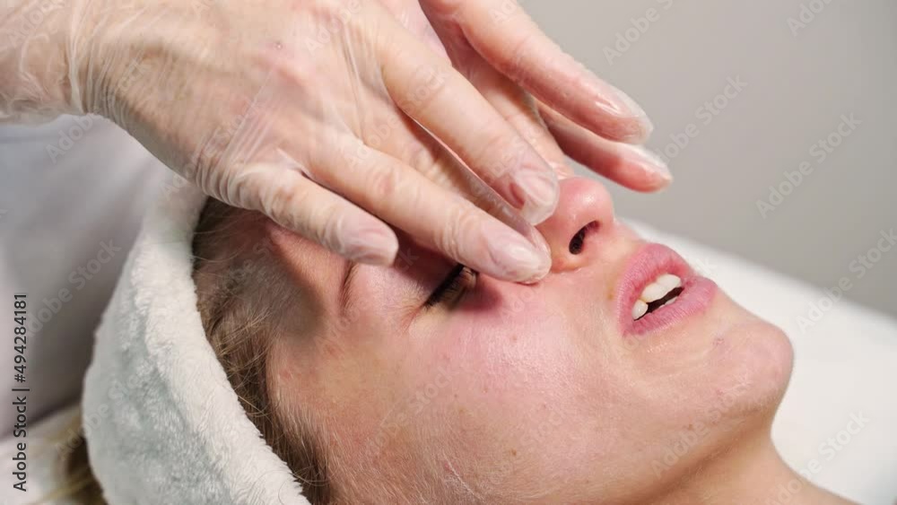 Face massage at spa salon. Doctor hands. Pretty female patient. Beauty treatment. Healthy skin procedure. Young woman head. Scrub rejuvenation. Facial dermatology mask. Detox therapy video Face massage at spa salon. Doctor hands. Pretty female patient. Beauty treatment. Healthy skin procedure. Young woman head. Scrub rejuvenation. Facial dermatology mask. Detox therapy video