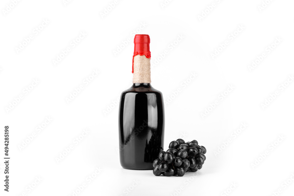 Red wine bottle isolated on white background with black grape.