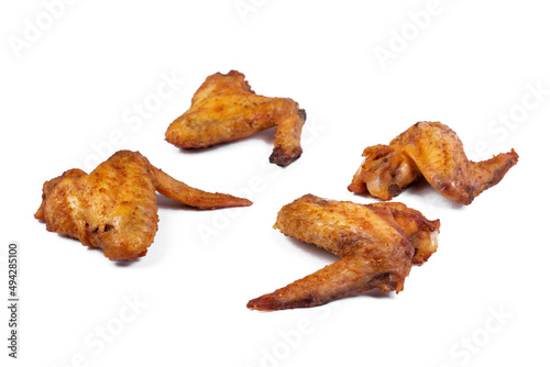 Fresh roasted chicken wing quarters on white isolated background