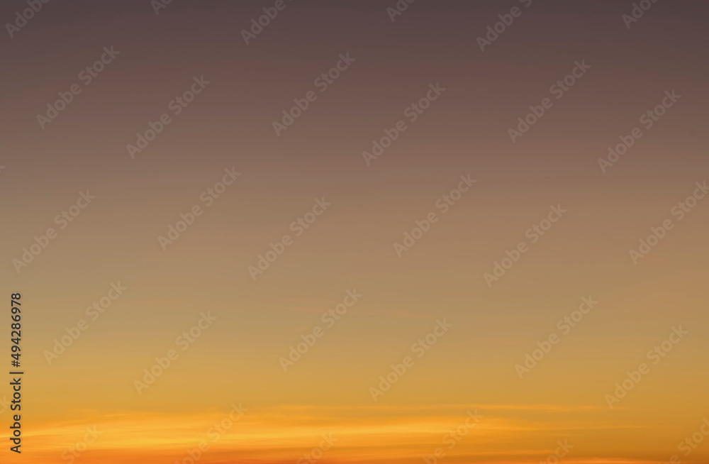 The sky before dawn was clear with an orange horizon and a blue atmosphere. orange dawn sky smooth orange gradient background of the start of the day Morning paradise with copy space. Sunset. Sunrise 