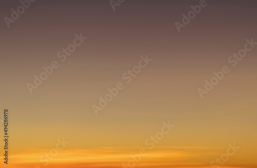 The sky before dawn was clear with an orange horizon and a blue atmosphere. orange dawn sky smooth orange gradient background of the start of the day Morning paradise with copy space. Sunset. Sunrise 