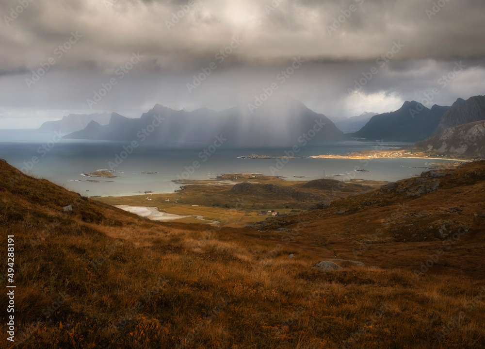 Heavy rain and sun over mountains and sea at Lofoten Islands in autumn Norway time Heavy rain and sun over mountains and sea at Lofoten Islands in autumn Norway time