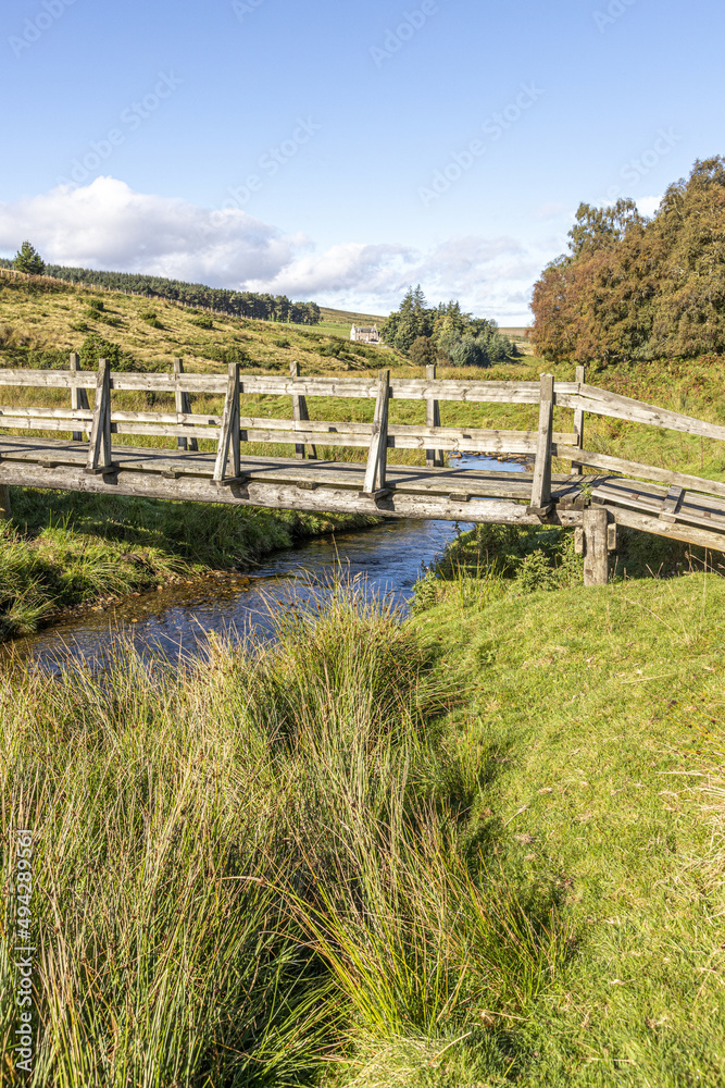 A wooden footbridge over Conglass Water at Blairnamarrow near Tomintoul, Moray, Scotland UK.