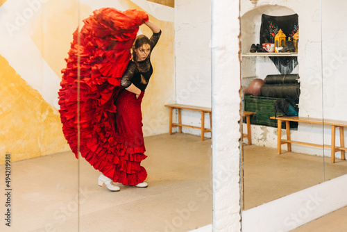 dancer dancing flamenco in a tailed gown photo