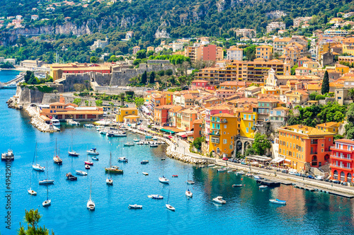 Fototapeta Naklejka Na Ścianę i Meble -  Panoramic view of beautiful luxury resort and bay on hills leading down to coast of French riviera Ville is situated between Nice city and Monaco.  Vibrant Travel Concept. Mediterranean Sea