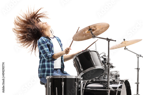 Energetic female drummer playing on a drum set photo