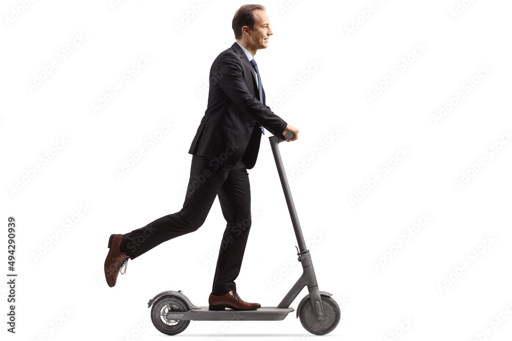 Full length profile shot of a businessman riding an electric scooter Full length profile shot of a businessman riding an electric scooter