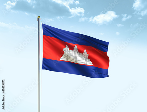 Cambodia national flag waving in blue sky with clouds. Cambodia flag. 3D illustration