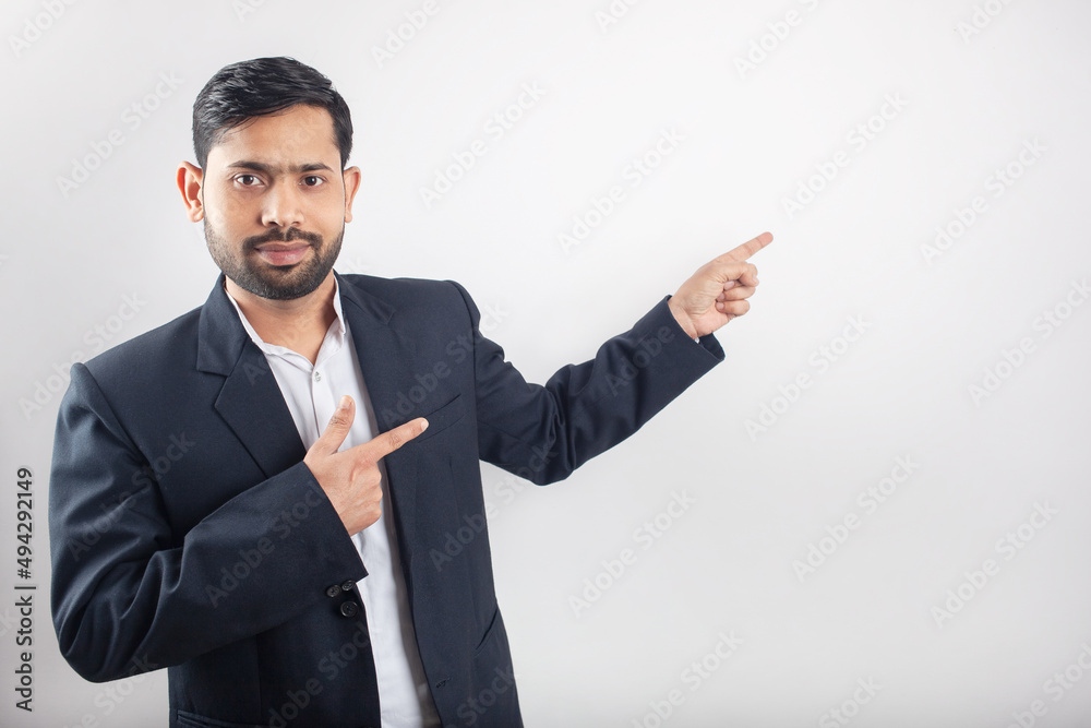 indian suit man indicating finger towards empty space in white background indian suit man indicating finger towards empty space in white background