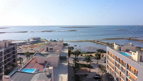 Aerial view of the urban area of portugal in the south of houses with modern infrastructure swimming pools overlooking the sea. Southern city of Portugal Olhao.