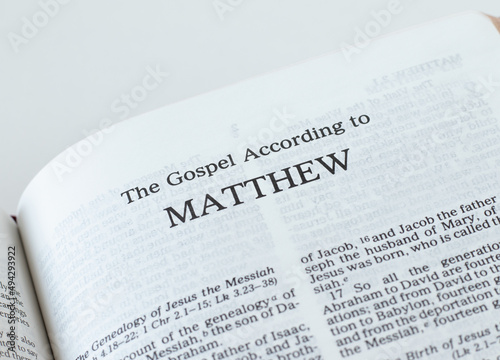 Matthew Gospel from Holy Bible Book inspired by God and Jesus Christ, a closeup. New Testament Scripture isolated on a white background.	