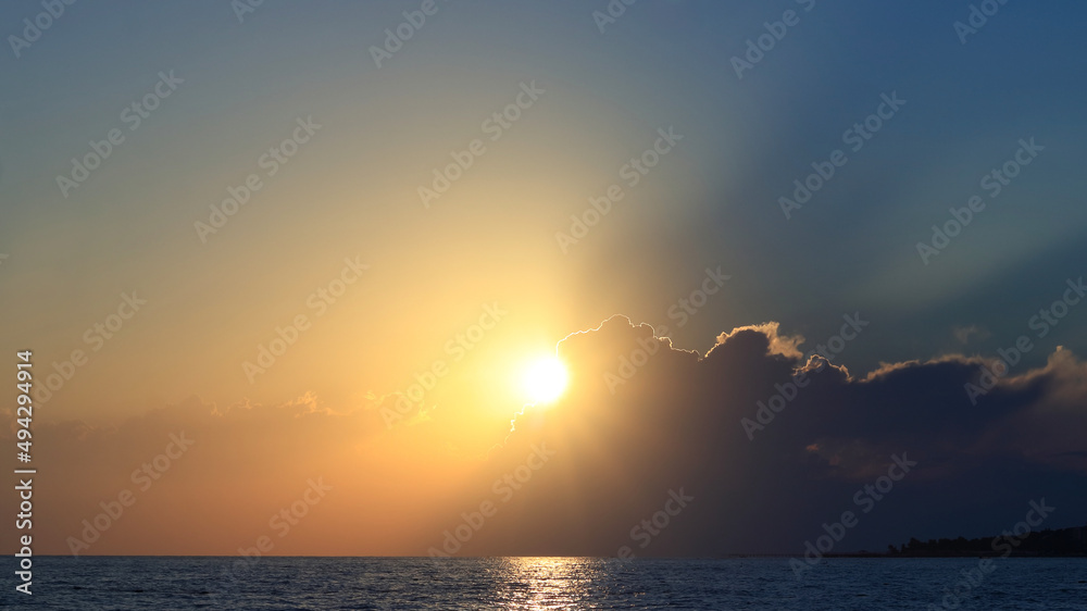 Bright beautiful Sunrise or Sunset at Sea. Bright sunset with a big sun under the Sea surface. Inspirational calm sea with sunset Sky. Ocean and Sky background. Colorful horizon over the water. Bright beautiful Sunrise or Sunset at Sea. Bright sunset with a big sun under the Sea surface. Inspirational calm sea with sunset Sky. Ocean and Sky background. Colorful horizon over the water.
