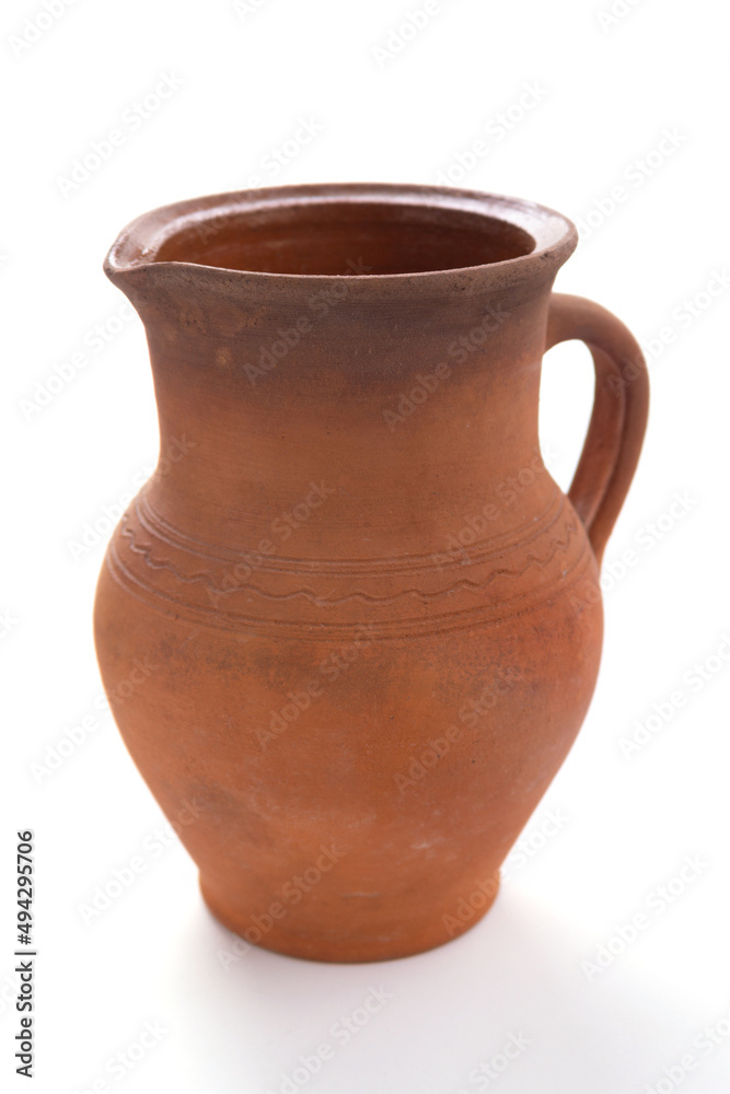 Old clay jug isolated at white background