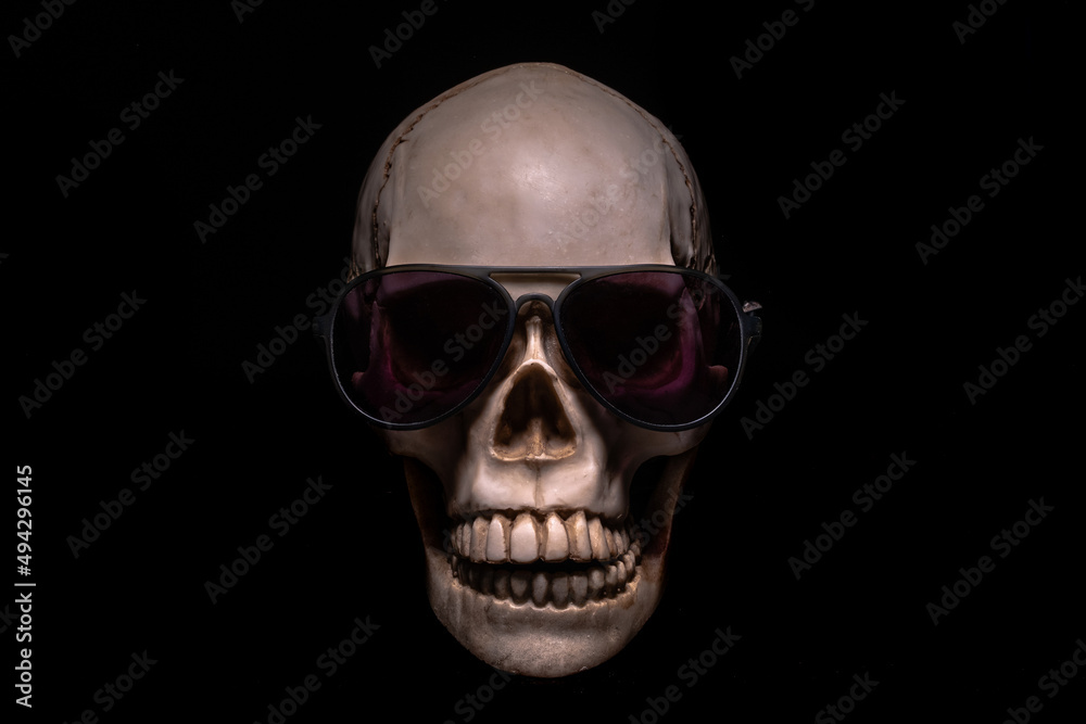 Fototapeta premium Skull in sunglasses on a black background