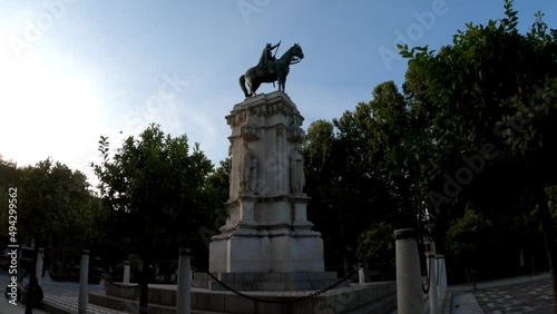 Seville, Spain, September 11, 2021: TILT SLOW MOTION SHOT - The New Square (Plaza Nueva) and monument of Fernando III The Saint (Fernando III El Santo). photo