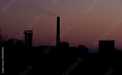 Factory in LItovel town with sunrise colors on sky photo