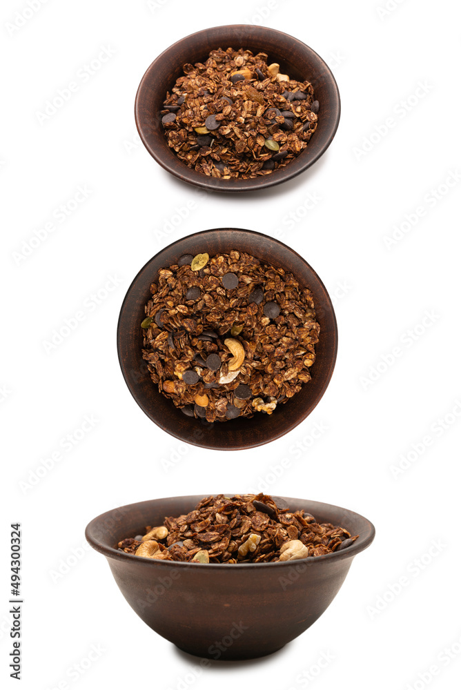 Chocolate granola cereal with nuts in a bowl background. Chocolate granola cereal with nuts in a bowl background.