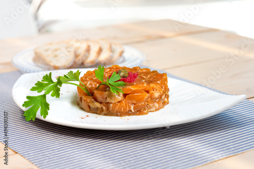 Salmon tartare with caper caviar and decorative parsley