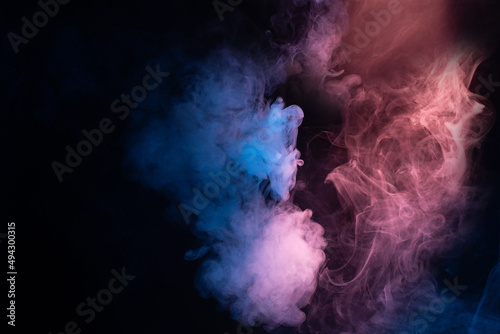 Blue and pink steam on a black background. photo