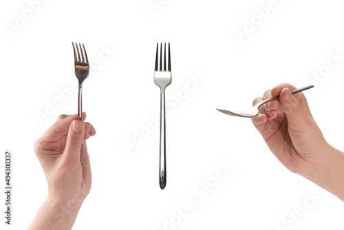 Fork in woman hand isolated on white. © Nikolay