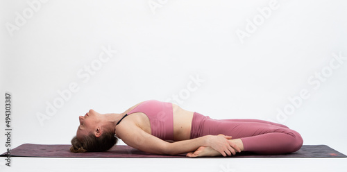 Billede på lærred woman doing yoga on a white background Supta Virasana or reclining hero pose