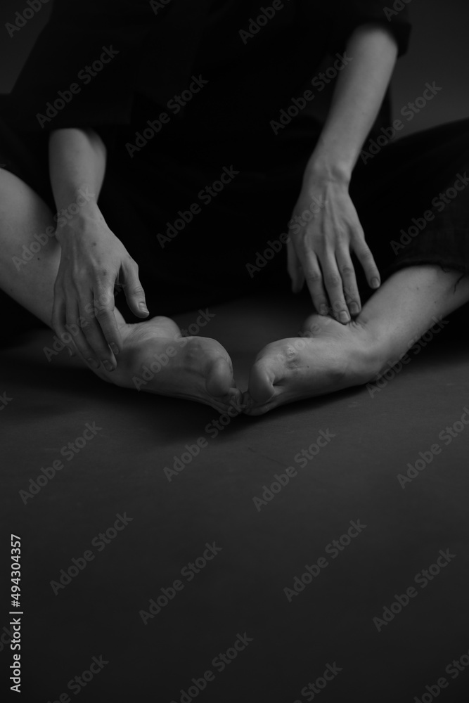 Black and white photo of body parts. intertwining of arms and legs