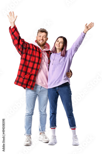 Cool happy young couple in hoodies on white background
