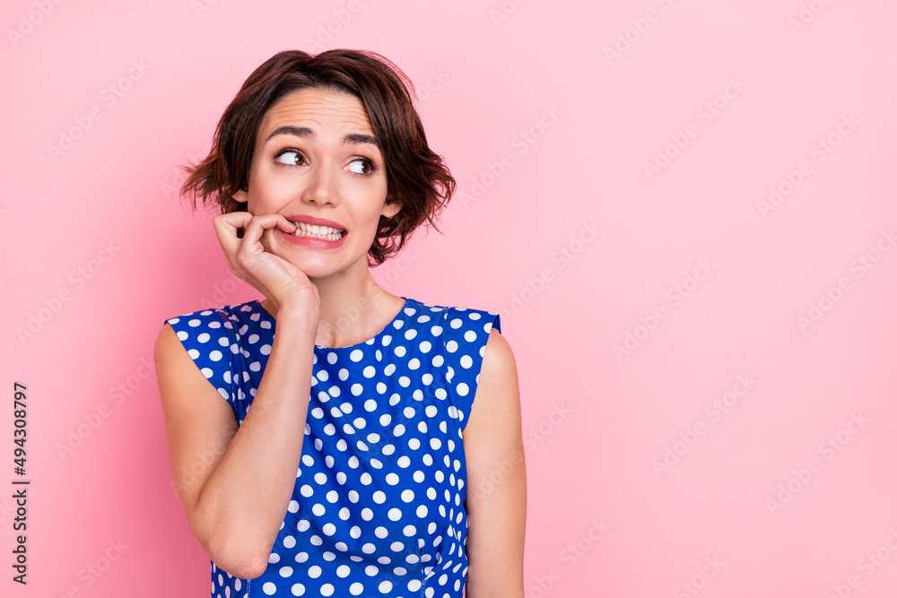 Portrait of stressed bad mood lady looking empty space worrying bite fingers isolated on pink color background Portrait of stressed bad mood lady looking empty space worrying bite fingers isolated on pink color background