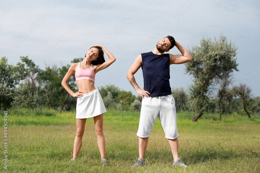 Sporty young couple exercising in park Sporty young couple exercising in park