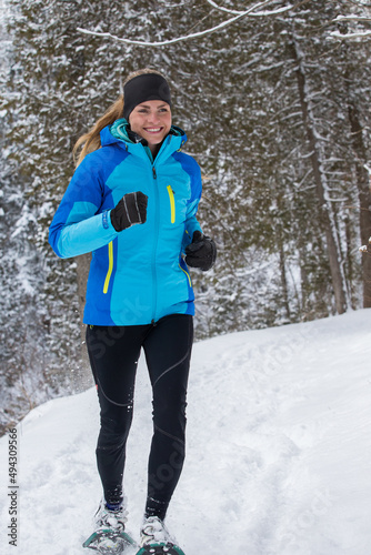 Obraz na płótnie Beautiful woman on snowshoes in the forest in the winter in Canada. w salonie