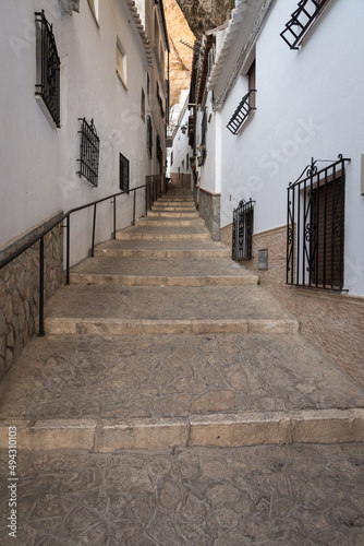 Narrow street with houses caves built into the mountain in the beautiful and famous white village of Setenil de las Bodegas at daylight, Cadiz province, Andalusia, Spain © JMDuran Photography