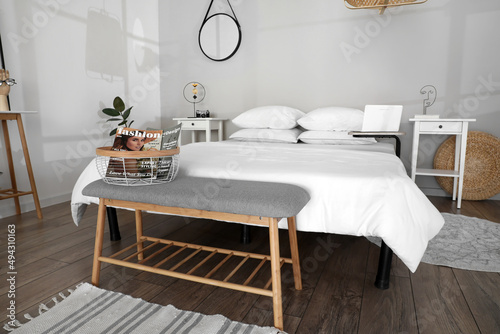 Interior of modern bedroom with bench and comfy bed © Pixel-Shot