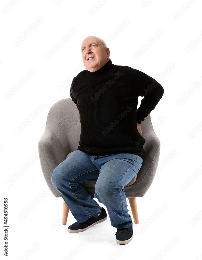 Senior man suffering from back pain in armchair on white background Senior man suffering from back pain in armchair on white background