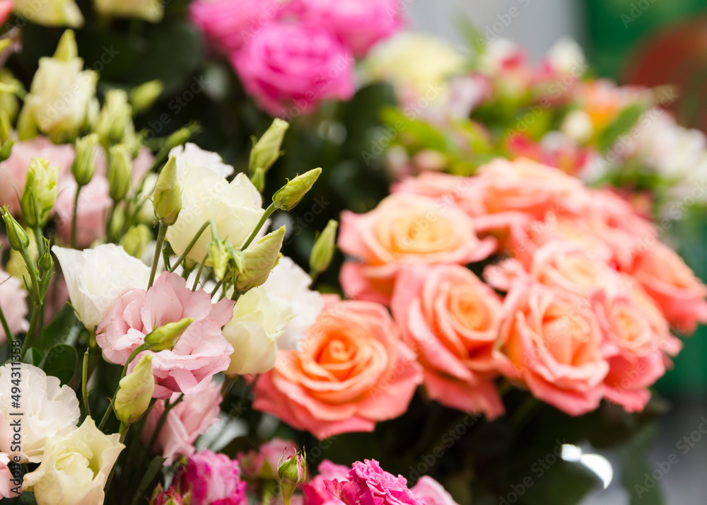A beautiful bright bouquet of blooming fresh roses for a gift collected by an experienced florist