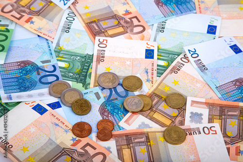 Background of banknotes and euro coins of different denominations close-up